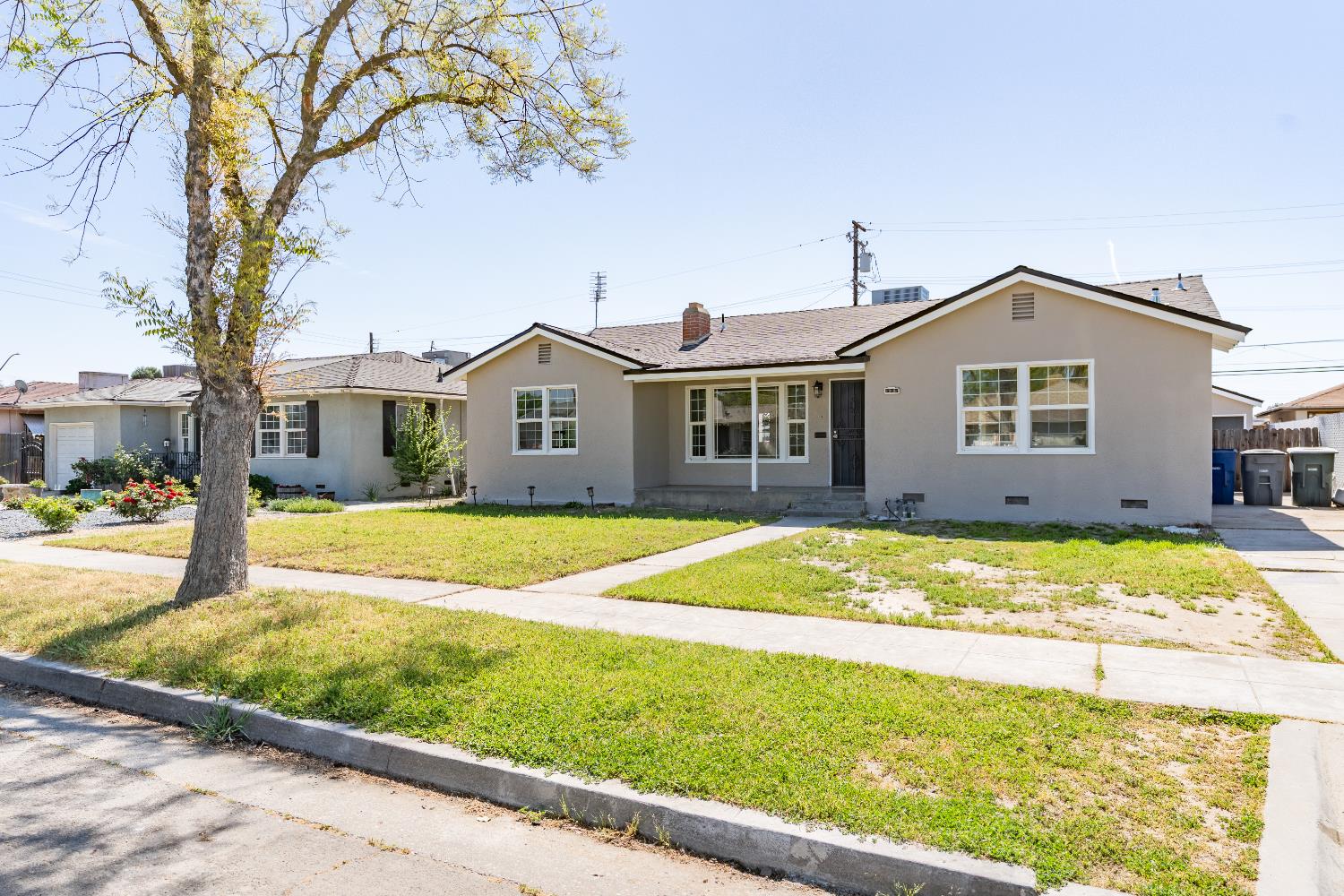 535 West Terrace Avenue Fresno, CA 93705 - Photo 2 of 18 a view of a house with a backyard and a tree