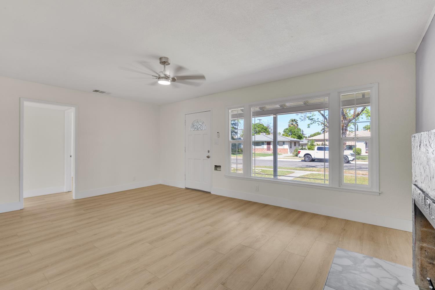 535 West Terrace Avenue Fresno, CA 93705 - Photo 3 of 18 an empty room with wooden floor and windows