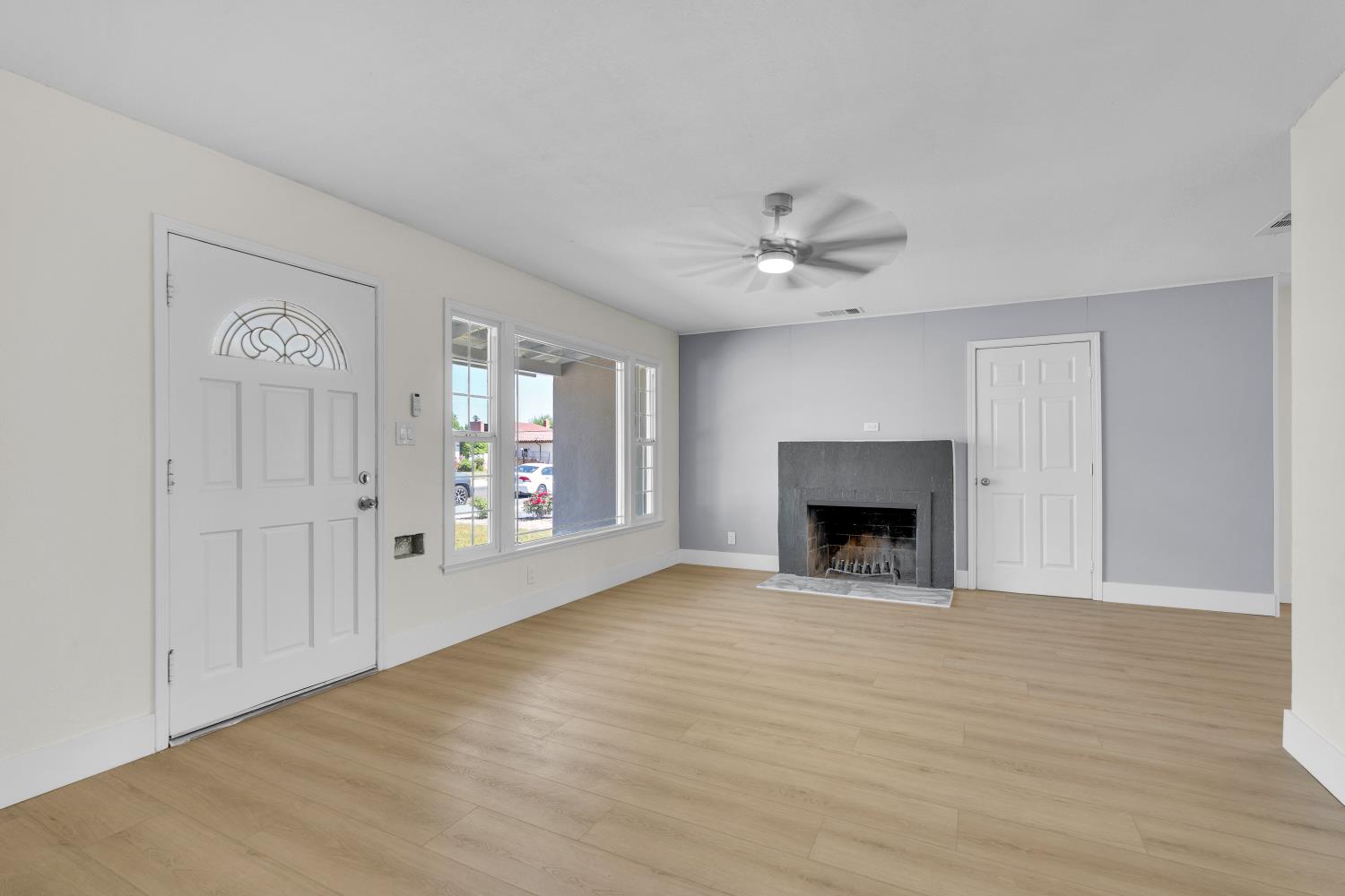 535 West Terrace Avenue Fresno, CA 93705 - Photo 4 of 18 a view of an empty room with a fireplace and a window