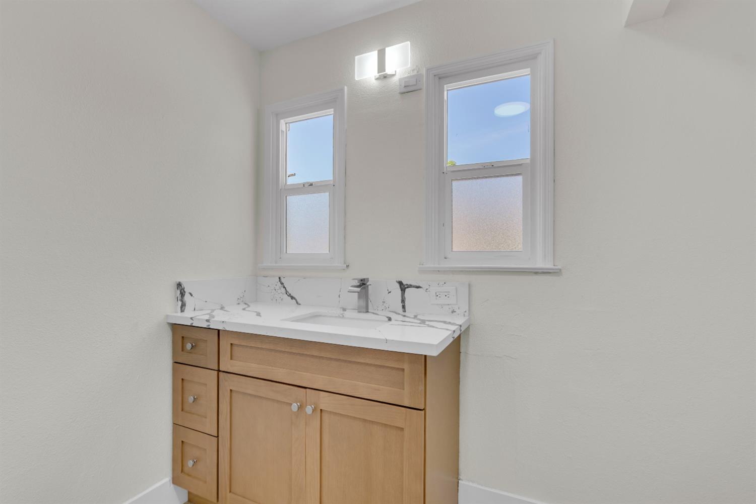 535 West Terrace Avenue Fresno, CA 93705 - Photo 6 of 18 a bathroom with a sink and a mirror