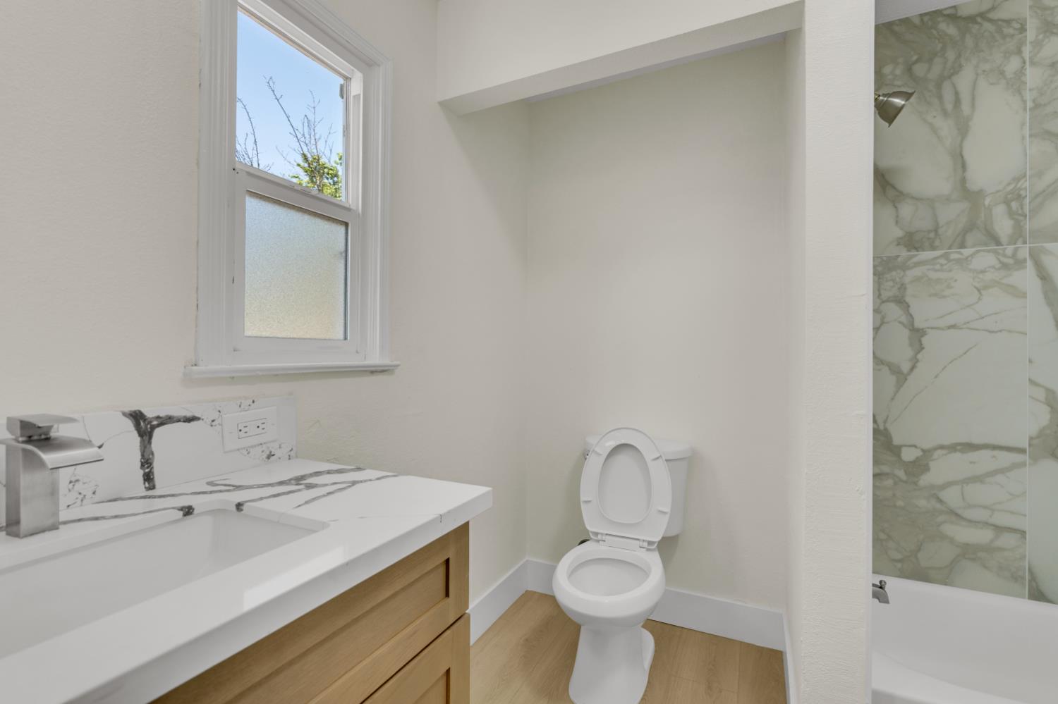 535 West Terrace Avenue Fresno, CA 93705 - Photo 7 of 18 a bathroom with a sink toilet and vanity