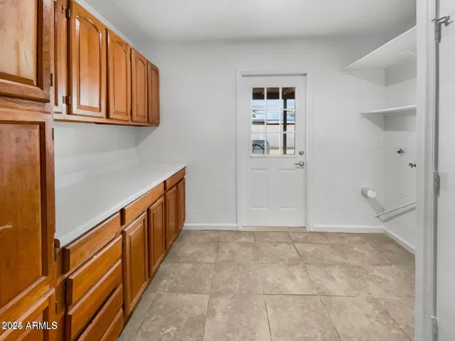 a view of a kitchen with wooden floor and cabinets