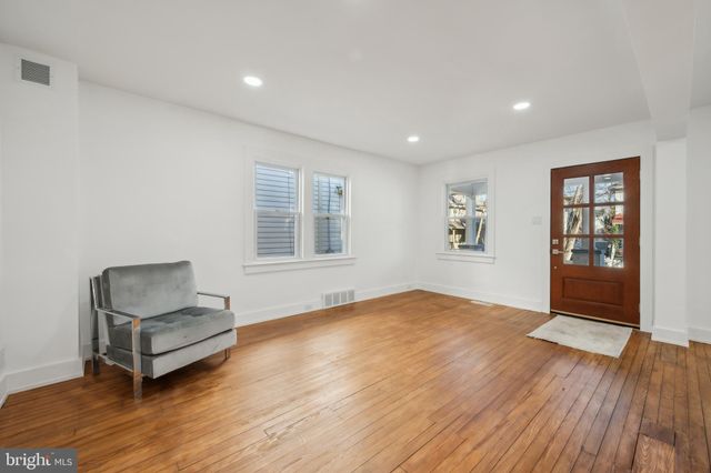 a view of a kitchen with a sink and chairs