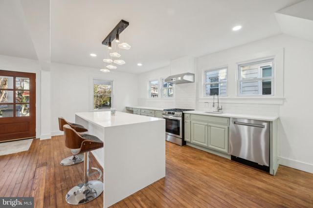 a kitchen with a sink cabinets and window
