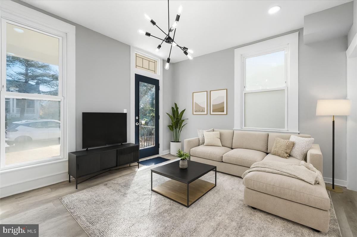 3414 Harford Road Baltimore, MD 21218 - Photo 2 of 32 a living room with furniture a flat screen tv and a window