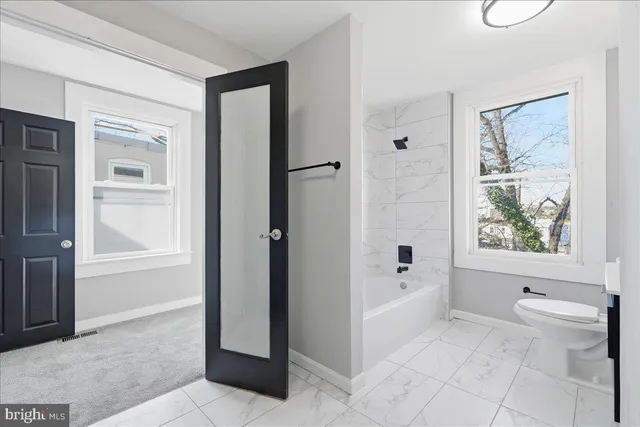 a bathroom with a bathtub and a shower