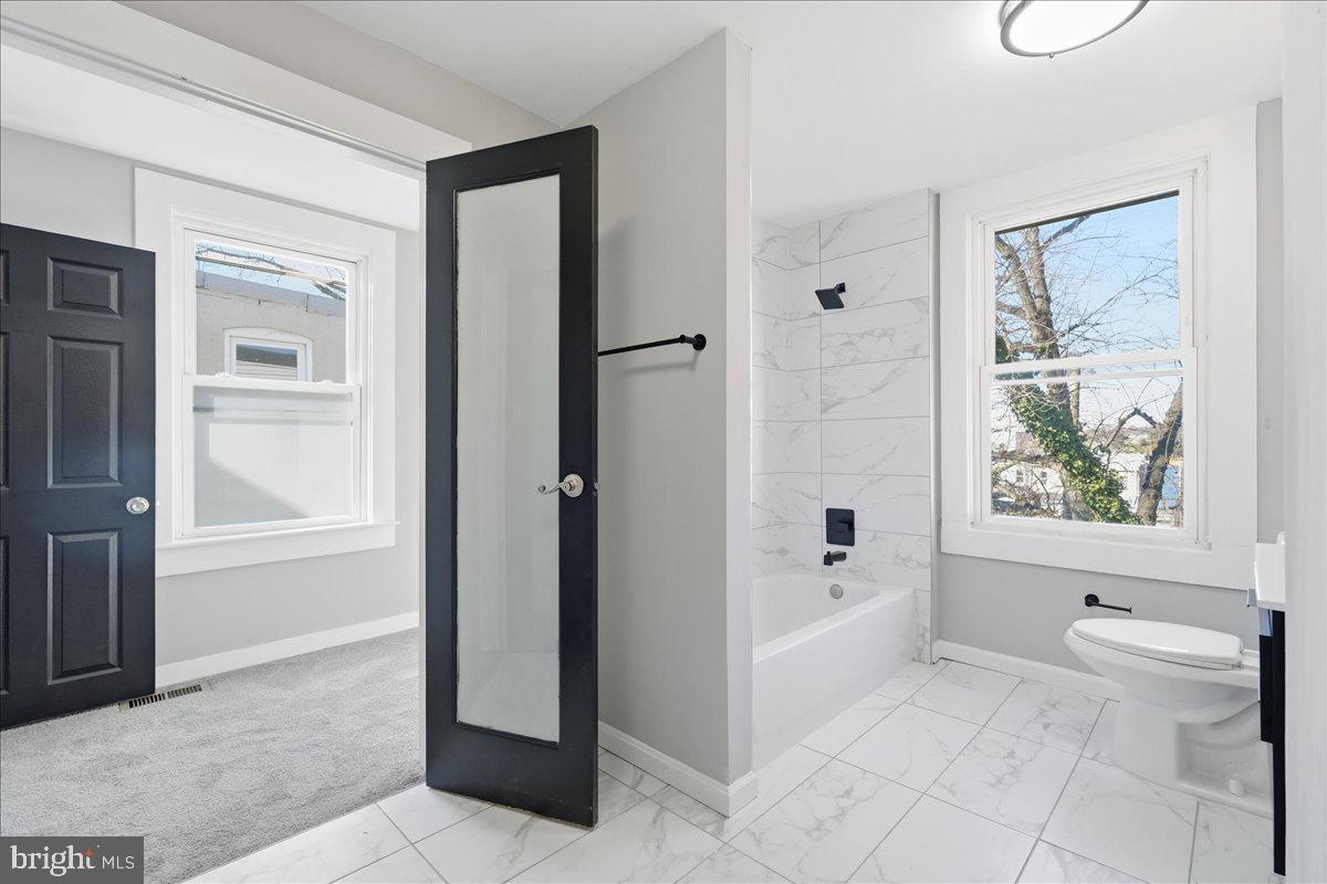 3414 Harford Road Baltimore, MD 21218 - Photo 24 of 32 a bathroom with a bathtub and a shower