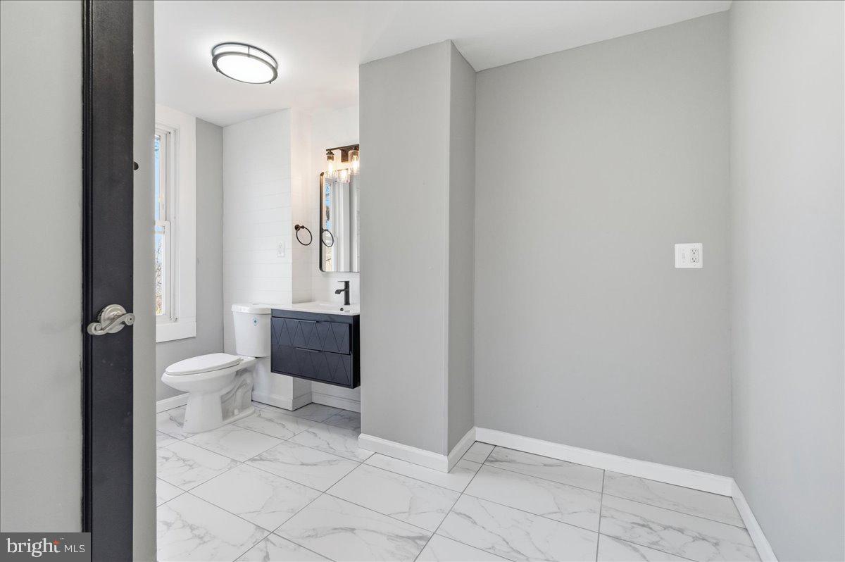 3414 Harford Road Baltimore, MD 21218 - Photo 25 of 32 a bathroom with a granite countertop toilet and a sink