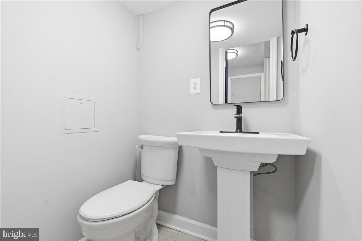 3414 Harford Road Baltimore, MD 21218 - Photo 27 of 32 a bathroom with a toilet sink and mirror