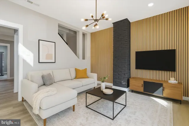a living room with furniture a flat screen tv and a fireplace