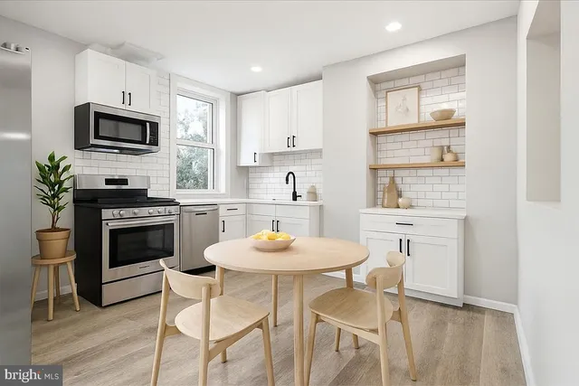 a kitchen with a stove a microwave and cabinets