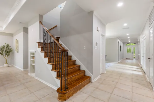 a dining room with furniture a chandelier and window
