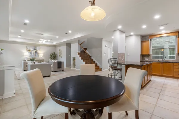 a living room with furniture a fireplace and a large window