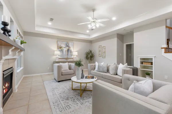a living room with furniture and a fireplace