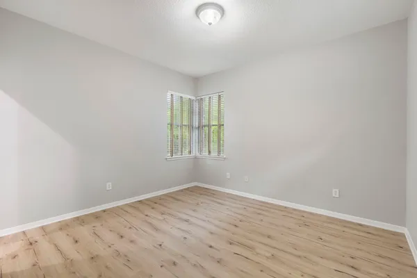 a bedroom with a large bed and a large window