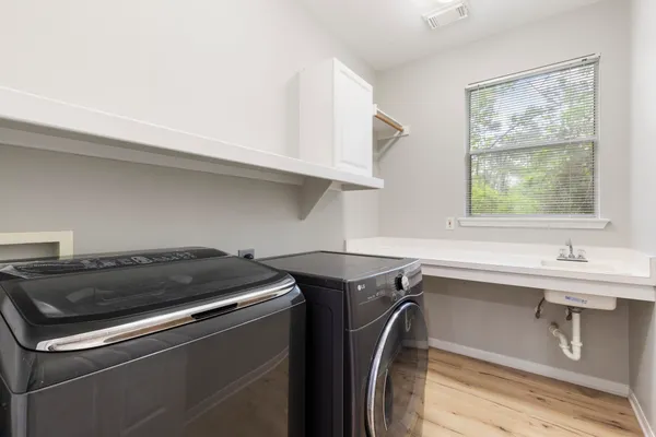 a bathroom with a sink tub vanity and mirror