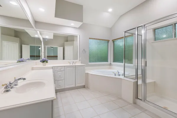 a view of backyard with table and chairs and wooden fence