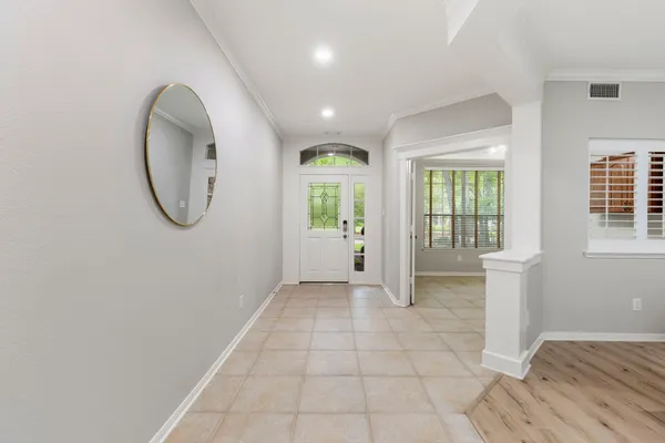 a view of entryway with wooden floor and windows