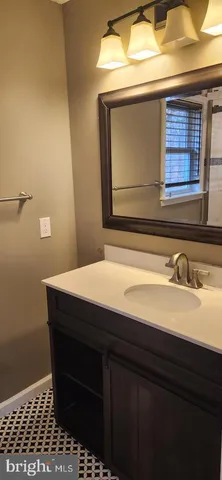 a bathroom with a sink a vanity and a window