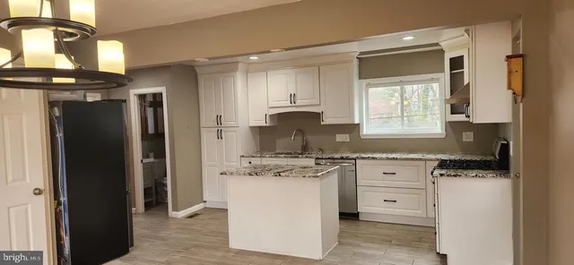 a kitchen with a stove a sink and a refrigerator