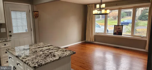 a view of a kitchen counter space and wooden floor