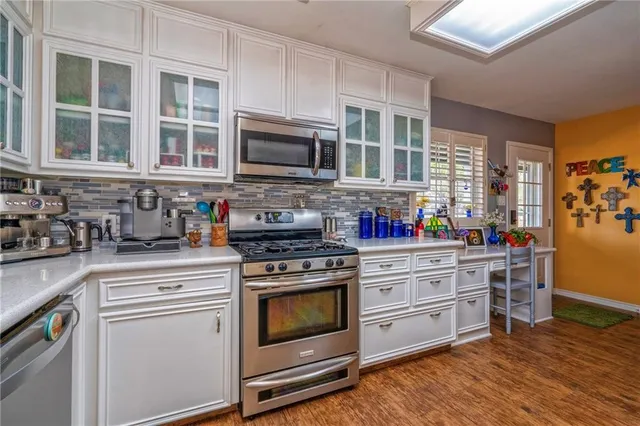 a kitchen with stainless steel appliances granite countertop a stove and a sink