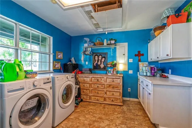a view of storage and utility room with washer and dryer