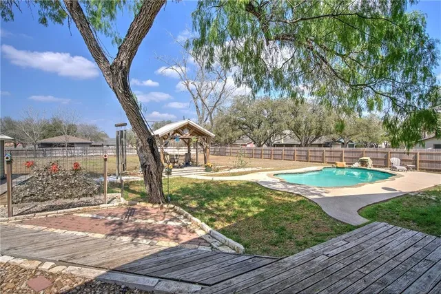 a view of a yard with swimming pool