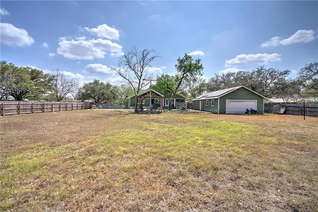 a house view with swimming pool and trees