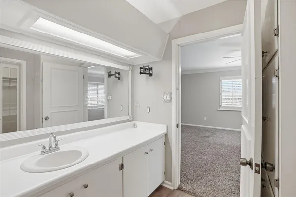 a spacious bathroom with a granite countertop sink a toilet and shower