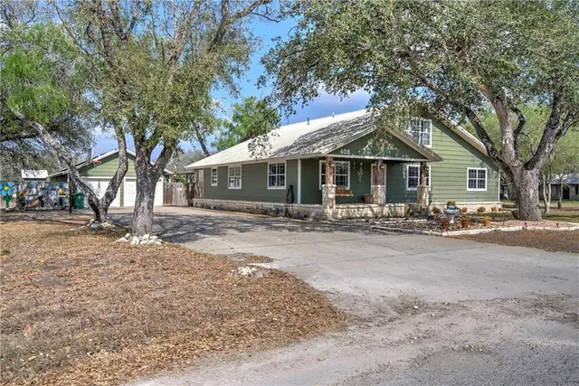 a front view of a house with yard patio and green space