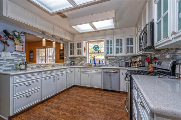 a kitchen with stainless steel appliances granite countertop a stove and a sink