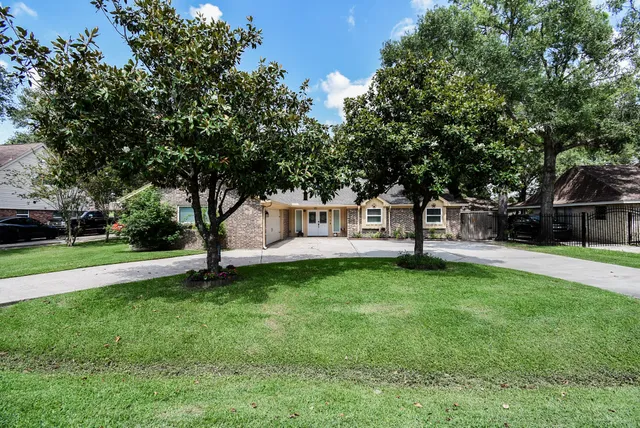 a view of a house with garden and a bench