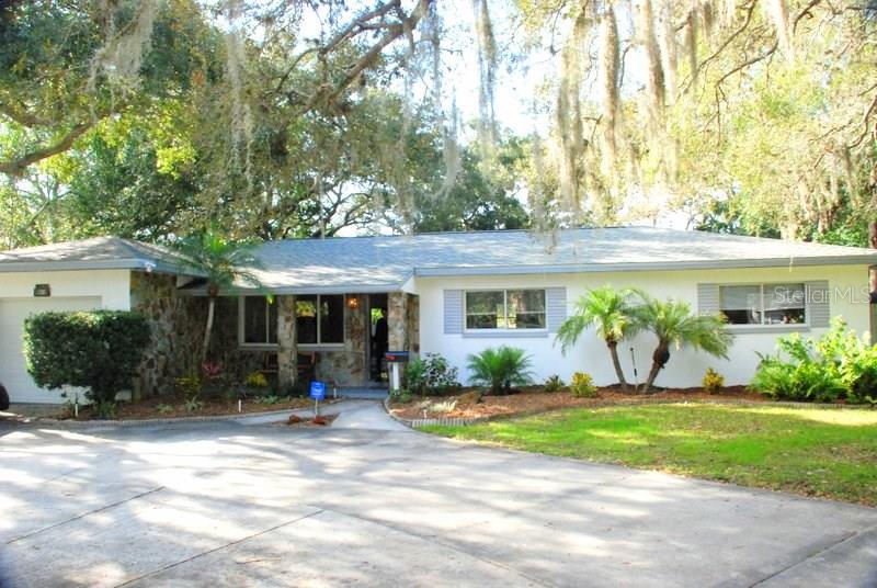 738 Country Club Road North St. Petersburg, FL 33710 - Photo 1 of 1 front view of a house with a yard
