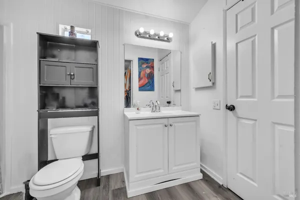 a bathroom with a toilet sink and mirror