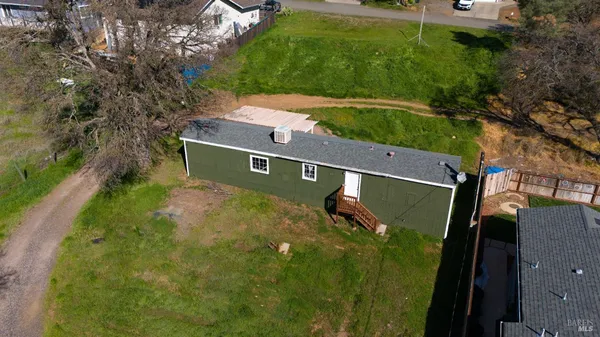 an aerial view of a house with a yard basket ball court
