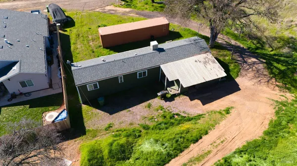 an aerial view of a house with a yard
