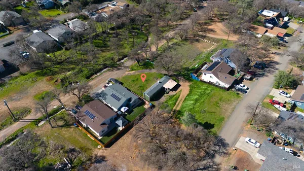 an aerial view of a house with a garden and swimming pool