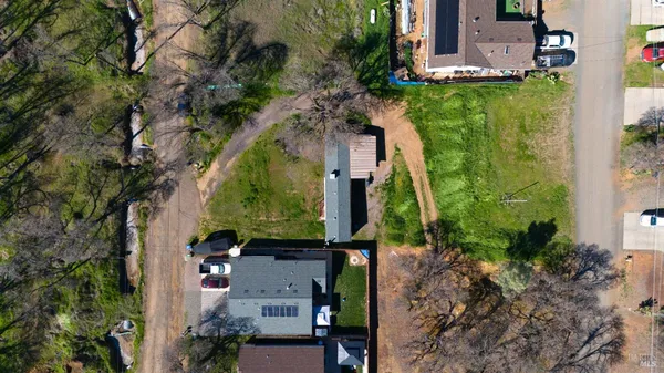 an aerial view of a house with a yard