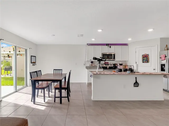 a living room with furniture and view of kitchen