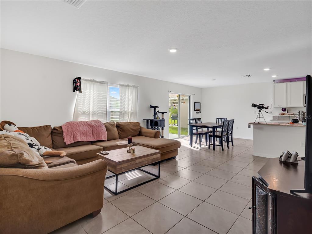 16669 Windmill Forge Pass Wimauma, FL 33598 - Photo 13 of 44 a living room with furniture and view of kitchen