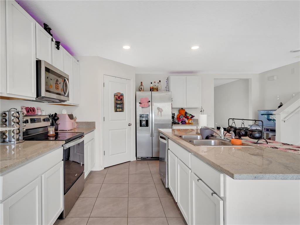 16669 Windmill Forge Pass Wimauma, FL 33598 - Photo 14 of 44 a kitchen with a sink dishwasher stove and refrigerator