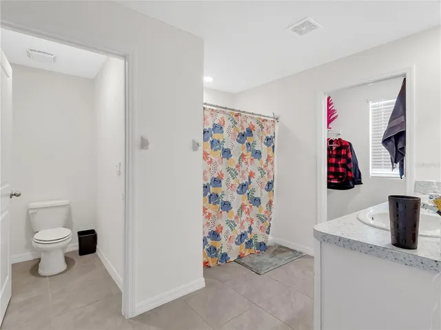 a bathroom with double vanity sinks vanity and a mirror