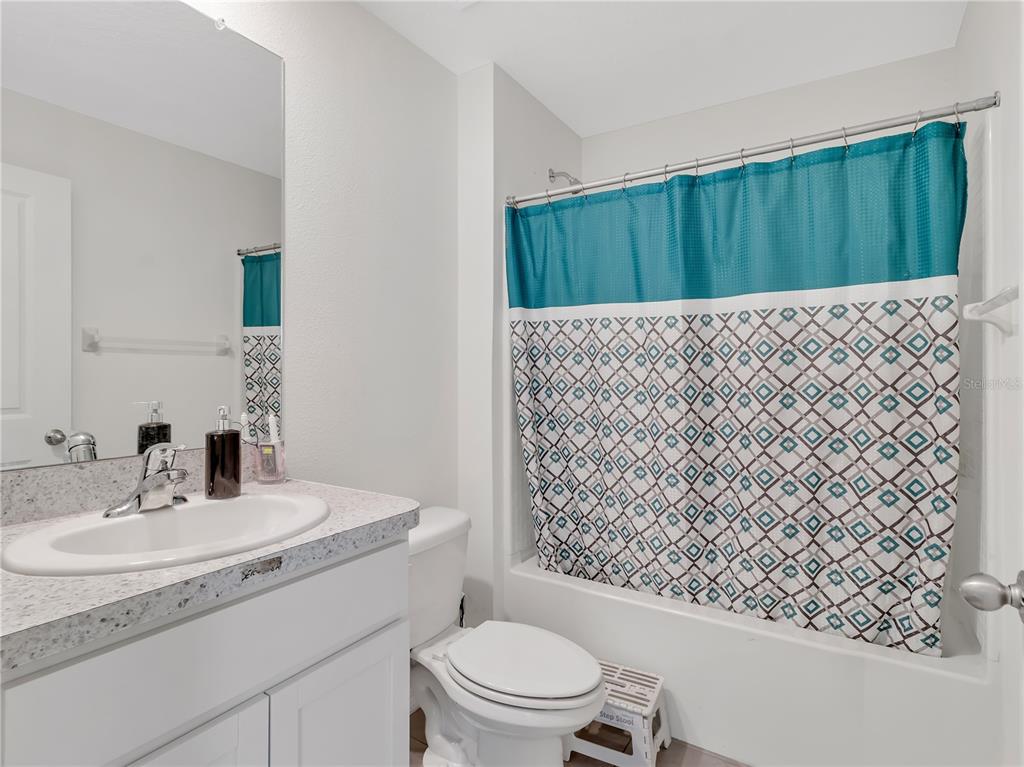 16669 Windmill Forge Pass Wimauma, FL 33598 - Photo 18 of 44 a bathroom with a sink toilet and shower