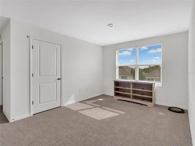 a bedroom with two beds and a window