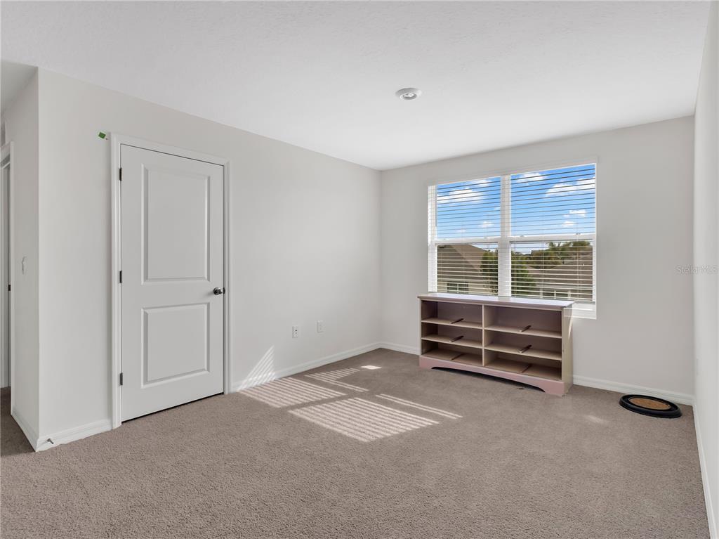 16669 Windmill Forge Pass Wimauma, FL 33598 - Photo 19 of 44 a view of an empty room with a window