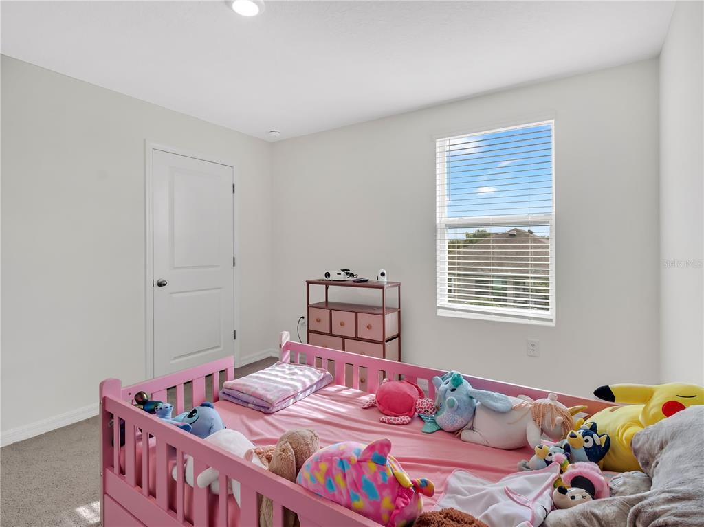 16669 Windmill Forge Pass Wimauma, FL 33598 - Photo 20 of 44 a bedroom with two beds and a window