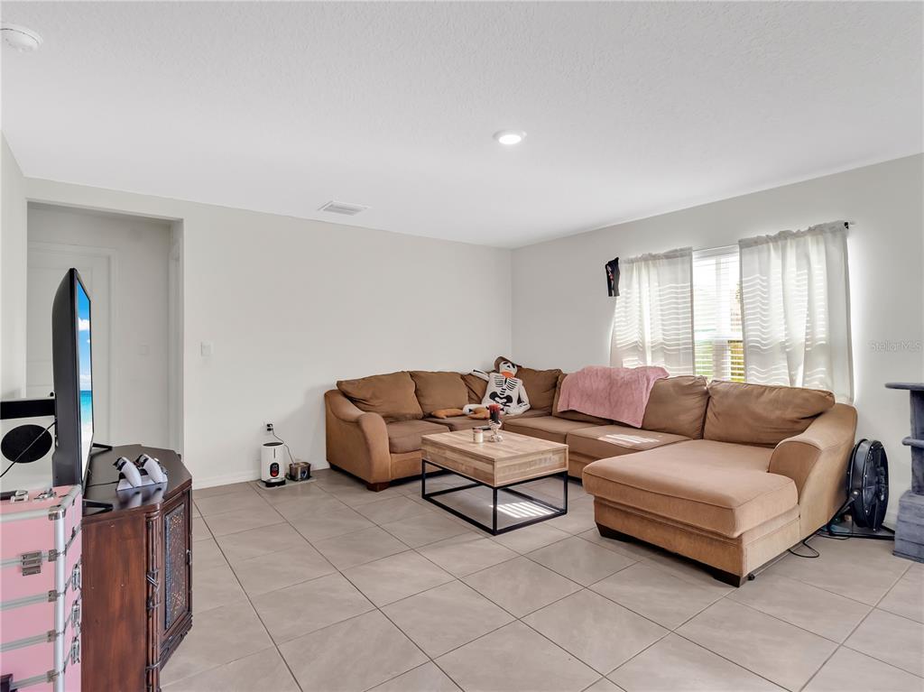 16669 Windmill Forge Pass Wimauma, FL 33598 - Photo 22 of 44 a living room with furniture and a flat screen tv