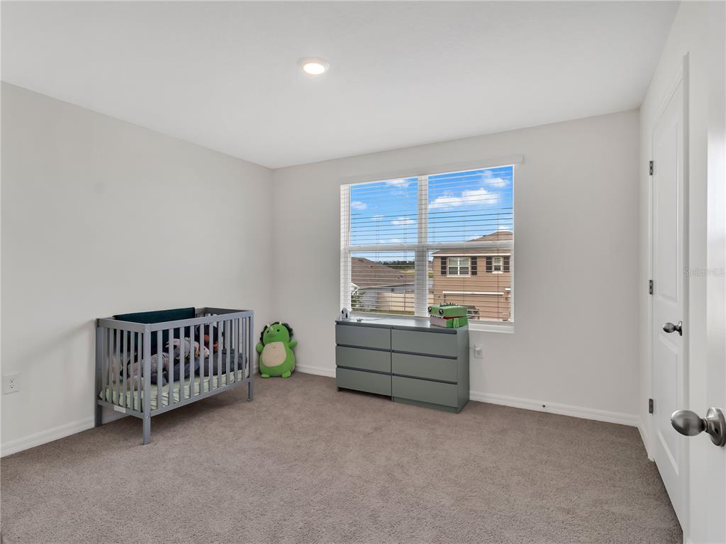 16669 Windmill Forge Pass Wimauma, FL 33598 - Photo 26 of 44 a room with stairs and a window