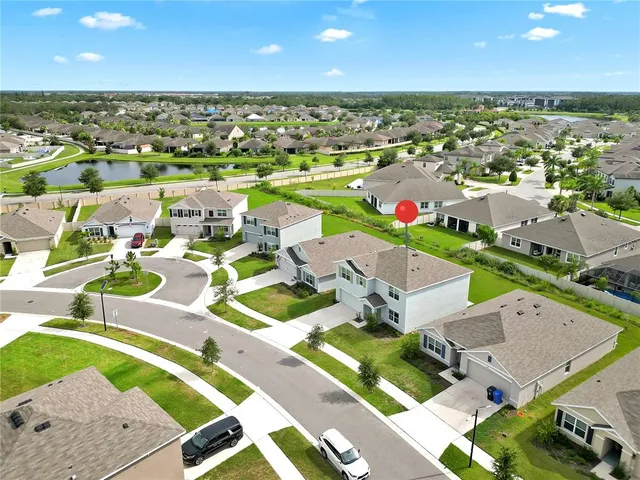 an aerial view of residential houses with outdoor space and street view
